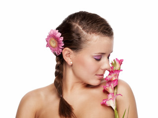 Pretty young woman smelling pink flower - isolated