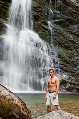 young man and waterfall