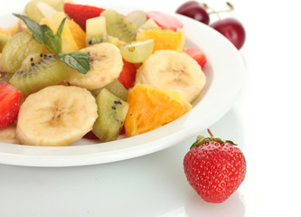 Fresh fruits salad on plate and berries isolated on white