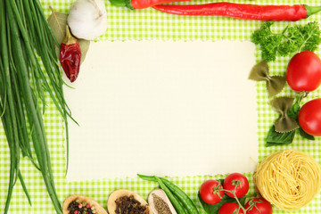paper for recipes,vegetables and spices on green background