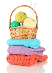 Sweaters and balls of wool isolated on white
