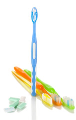 Toothbrushes and chewing gum isolated on white