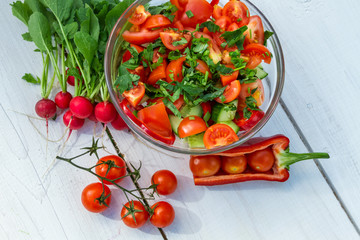 Fresh vegetables in sunny garden on old plank