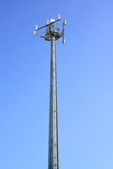 Obraz premium Telecommunications tower. Mobile phone station in a blue sky