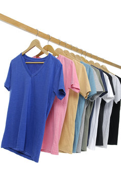 Variety of casual shirts on wooden hangers, isolated