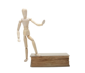 Wooden man and book, isolated on white