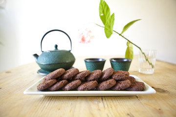 japanese tea with chocolate biscuits on wooden table
