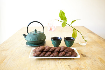 japanese tea with chocolate biscuits on wooden table