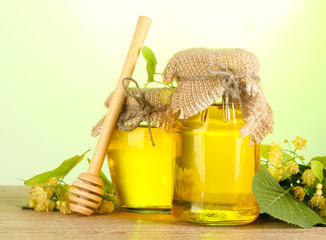 jars with linden honey and flowers