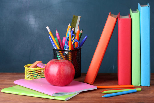Composition of books, stationery and an apple