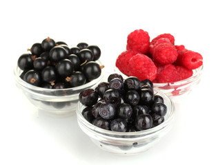 Fresh berries in transparent bowls isolated on white