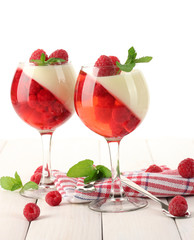 fruit jelly with raspberries in glasses on wooden table