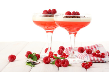 fruit jelly with berries in glasses on wooden table