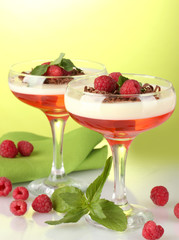 fruit jelly with berries in glasses on green background