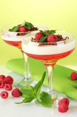 fruit jelly with berries in glasses on green background