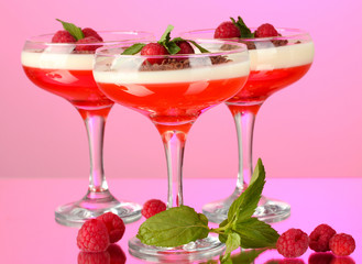 fruit jelly with berries in glasses on pink background