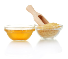 Gelatin in a bowl and wooden spoon isolated