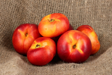 Ripe nectarines on canvas background close-up