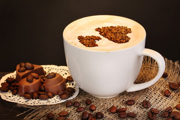 Latte on wooden table on brown background