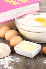 Eggs, flour and butter close-up on wooden table