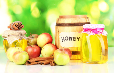 Honey and apples with cinnamon on natural background