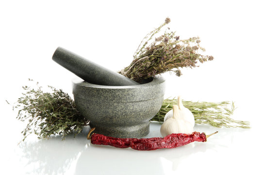 dried herbs in mortar and vegetables, isolatrd on white