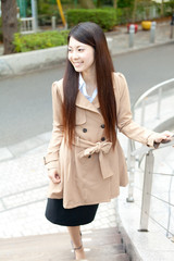 Fototapeta premium Beautiful business woman in the town. Portrait of asian.