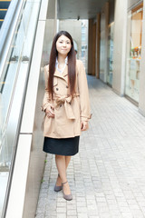 Beautiful business woman in the town. Portrait of asian.