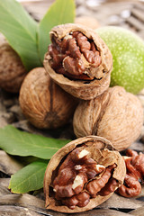 walnuts with green leaves, on  wicker background