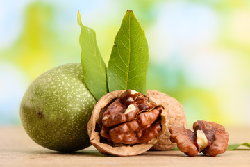 walnuts with green leaves, on green background
