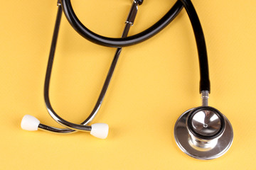 Stethoscope on orange background