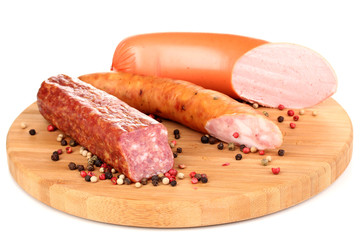 Tasty sausage on chopping board isolated on white