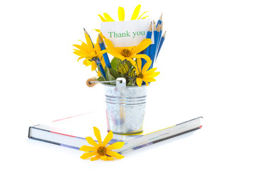 Autumn flowers with book and pencils
