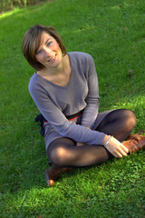 jeune femme assise dans l'herbe