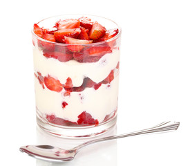 Glass of ripe strawberries with cream isolated on white
