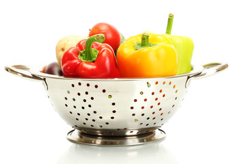 fresh vegetables in silver colander isolated on white