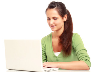 A young college girl sitting in front of a laptop