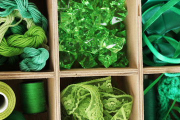 Green thread and material for handicrafts in box close-up