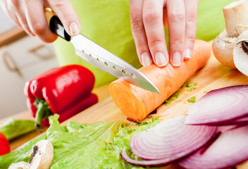 Woman's hands cutting vegetables