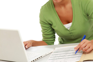 Closeup portrait of a young woman in front of a laptop