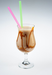 Milkshake with caramel over white background
