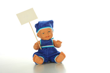 Baby doll with white placard isolated white bacgroun