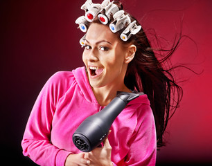 Woman wear hair curlers on head.