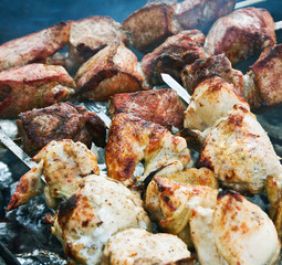 juicy slices of pork and chicken cooked over a fire