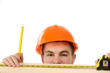 A young construcation worker measuring