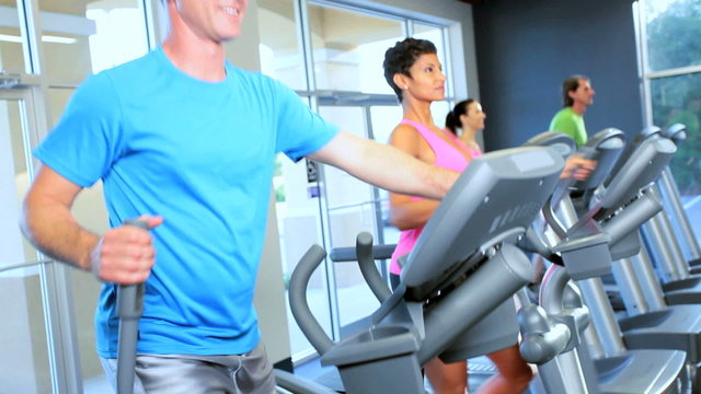 People Exercising Health Club Equipment