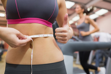 Thumbs up while measuring waist