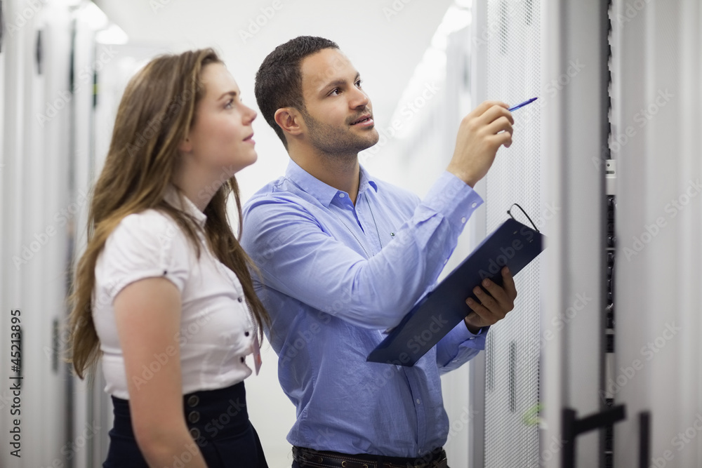 Aufkleber technicians with clipboard looking at servers