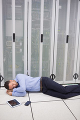 Technician sleeping in front of servers