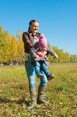 The young woman with the daughter on walk